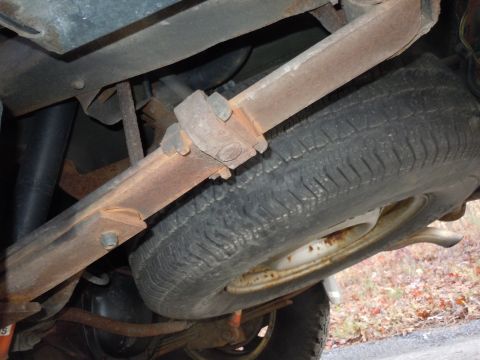 2001 Ford Crown Victoria - Underside view of a vehicle's suspension system and spare tire.