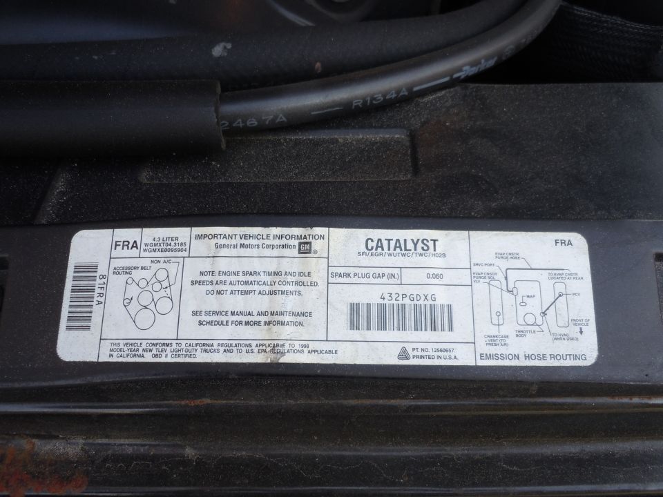 Underhood vehicle emission label with spark plug gap and emission hose routing diagram