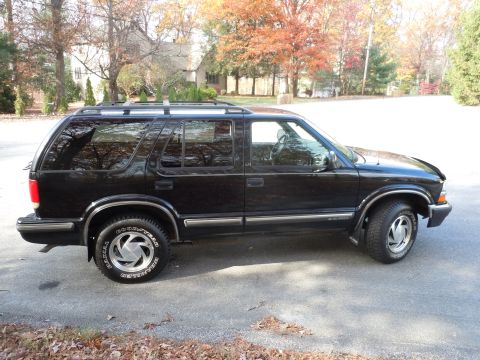 2001 Ford Crown Victoria - Side view of a black SUV with "GOODYEAR" visible on the tire.