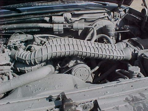 1993 Ford Bronco - The engine compartment is visible, showing various parts and hoses, with some text on a component.