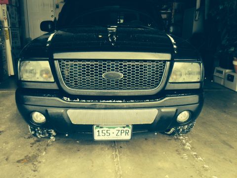2001 Ford Ranger - This black 2001 Ford Ranger is shown from the front, its distinctive honeycomb grille and a Colorado license plate.