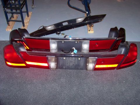 1999 Mercury Grand Marquis - Rear vehicle lighting components and trim pieces are displayed, possibly for sale or repair.