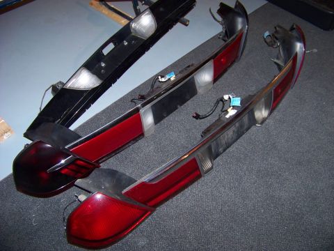1999 Mercury Grand Marquis - Car tail light assemblies are shown laid out on a carpeted floor.