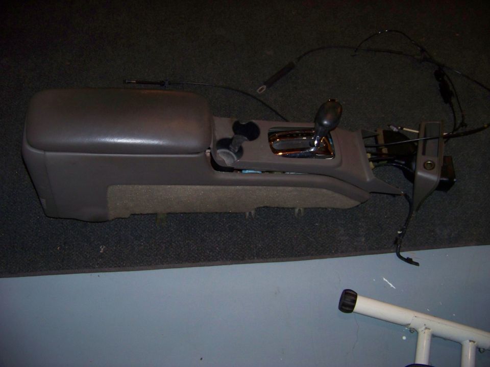 Brown car center console and gear shifter assembly with wiring