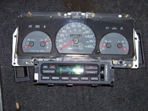 1999 Mercury Grand Marquis - This is a close-up of a car's instrument cluster and climate control panel, removed from the vehicle.