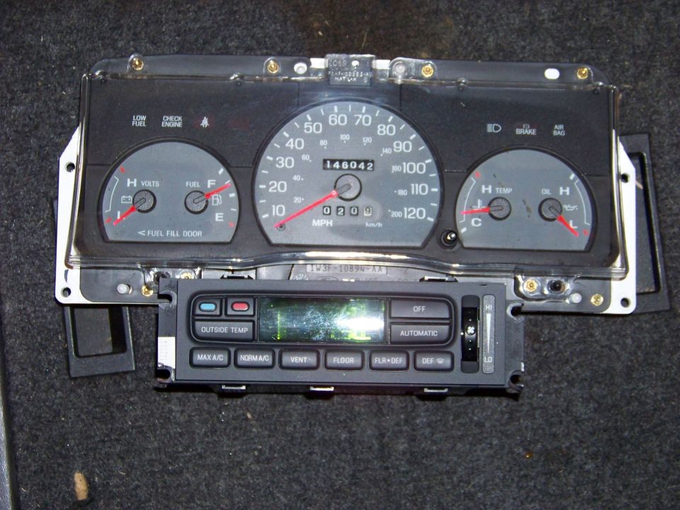 Car dashboard cluster with speedometer, fuel gauge, temp gauge, and climate controls