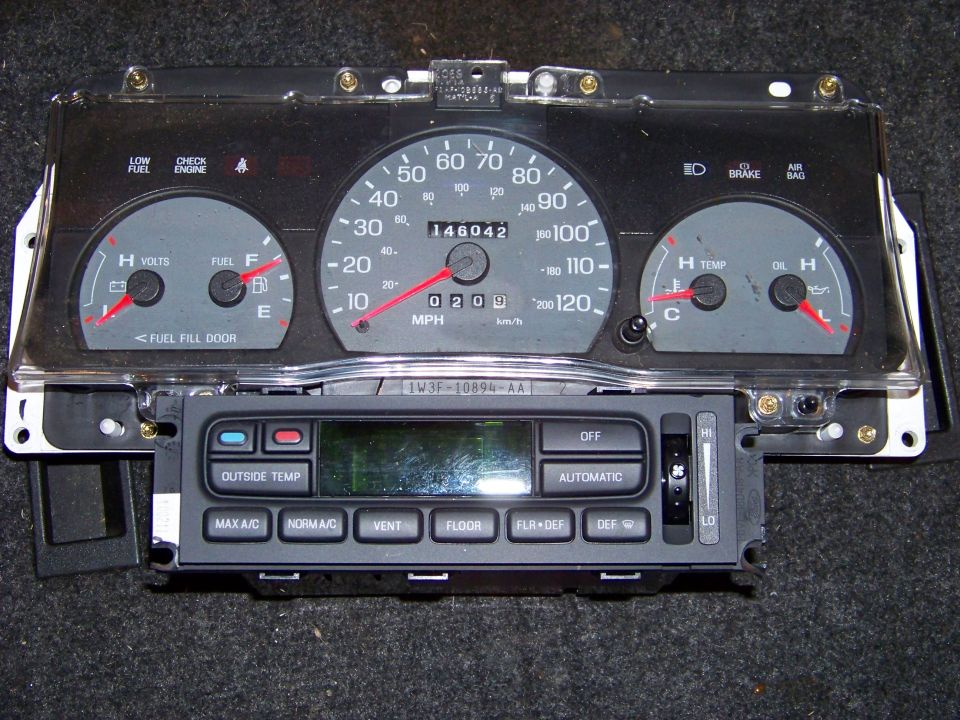 Car dashboard instrument cluster with odometer reading 146042, and climate control unit