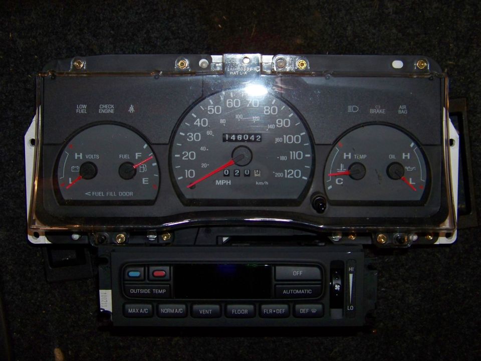 Instrument cluster with speedometer, fuel gauge, and temperature gauge, plus climate controls