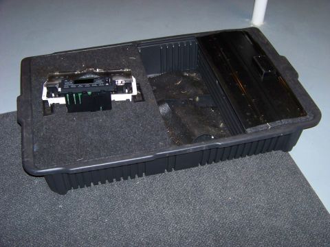 1999 Mercury Grand Marquis - Center console storage bin with radio unit removed, showing internal wiring connectors.