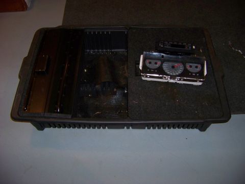 1999 Mercury Grand Marquis - A disassembled dashboard instrument cluster and center console storage bin are shown.
