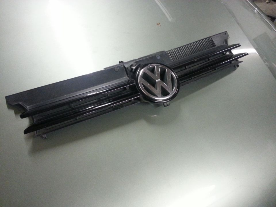 Volkswagen emblem on a black grille, likely for a car