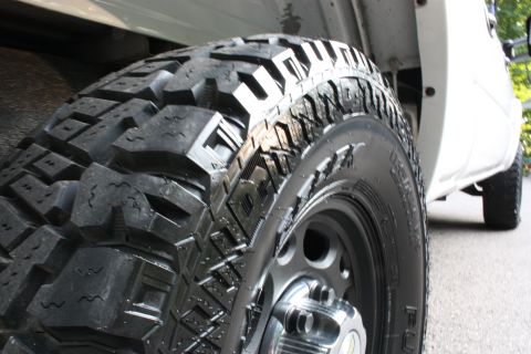 2006 Chevrolet Silverado 2500 - A close-up view of a heavy-duty truck tire with a deep tread pattern.