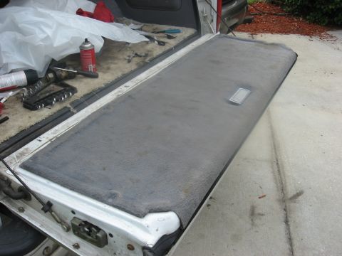 1994 Ford Bronco - Close-up view of the carpeted interior of a vehicle's tailgate, showing the latch mechanism.