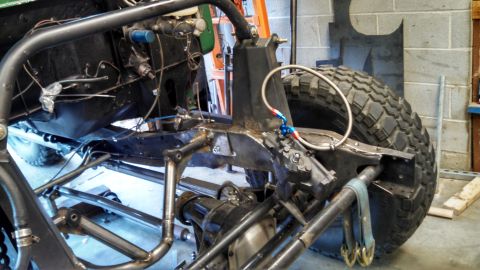 1967 Ford F-250 - Custom off-road vehicle frame and suspension components are shown during a build.