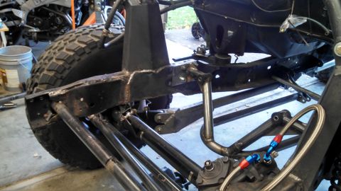 1967 Ford F-250 - The intricate suspension and reinforced frame of a custom off-road vehicle are visible in this detailed shot.