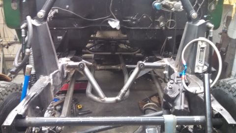1967 Ford F-250 - Close-up view of a vehicle's chassis and suspension system during construction or repair.