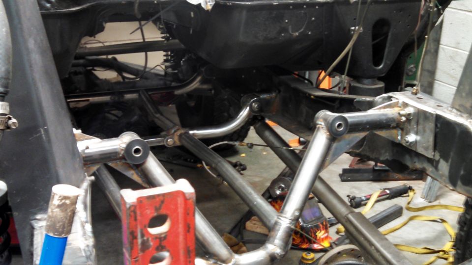 Vehicle frame with custom suspension modifications, viewed from below