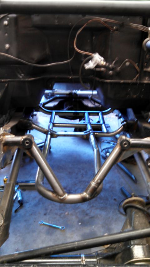 1967 Ford F-250 - Custom roll cage fabrication in progress, showing welded tubing and vehicle undercarriage components.