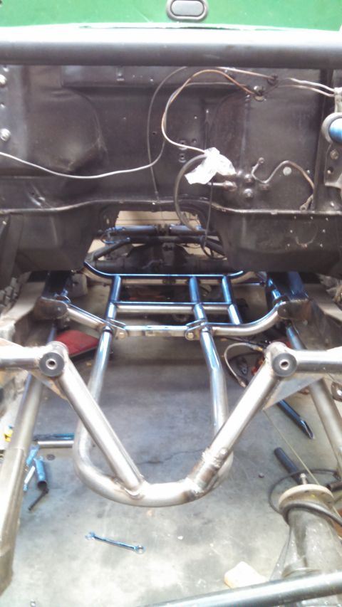 1967 Ford F-250 - Close-up view of custom suspension and chassis work, with visible wiring and metal tubing.