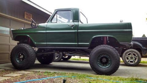 1967 Ford F-250 - This modified 1967 Ford F-250 features a significant lift kit and large off-road tires.