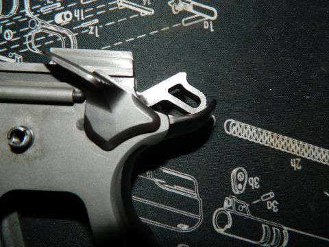 1979 Ford Bronco - Close-up of gun trigger assembly parts on a schematic mat.