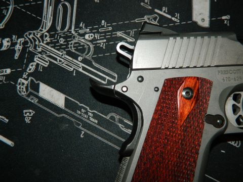 1979 Ford Bronco - A pistol with textured wood grips is shown against a detailed schematic diagram.