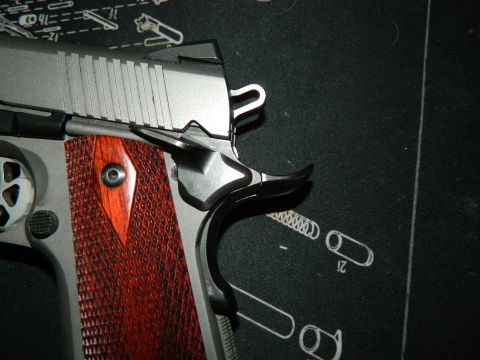1979 Ford Bronco - Close-up view of a pistol's grip and slide, showing detailed texture and metal finish.