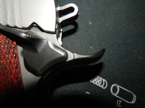 1979 Ford Bronco - A detailed view of a firearm's grip and slide, highlighting its construction and texture.