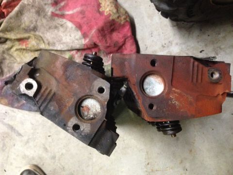 1993 Ford Bronco - Two rusty engine cylinder heads are shown, each with visible springs.