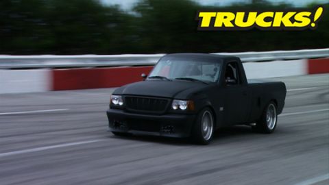 2001 Ford Ranger - This black 2001 Ford Ranger is captured in motion on a race track.