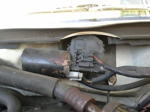 1991 Ford F-250 - Close-up of a corroded windshield wiper motor assembly, showing electrical connectors and wiring.