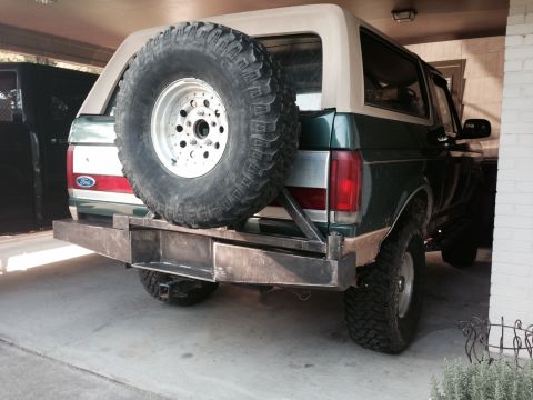 1989 Ford Bronco - The rear of a 1989 Ford Bronco, a custom bumper and a spare tire mounted on the tailgate.