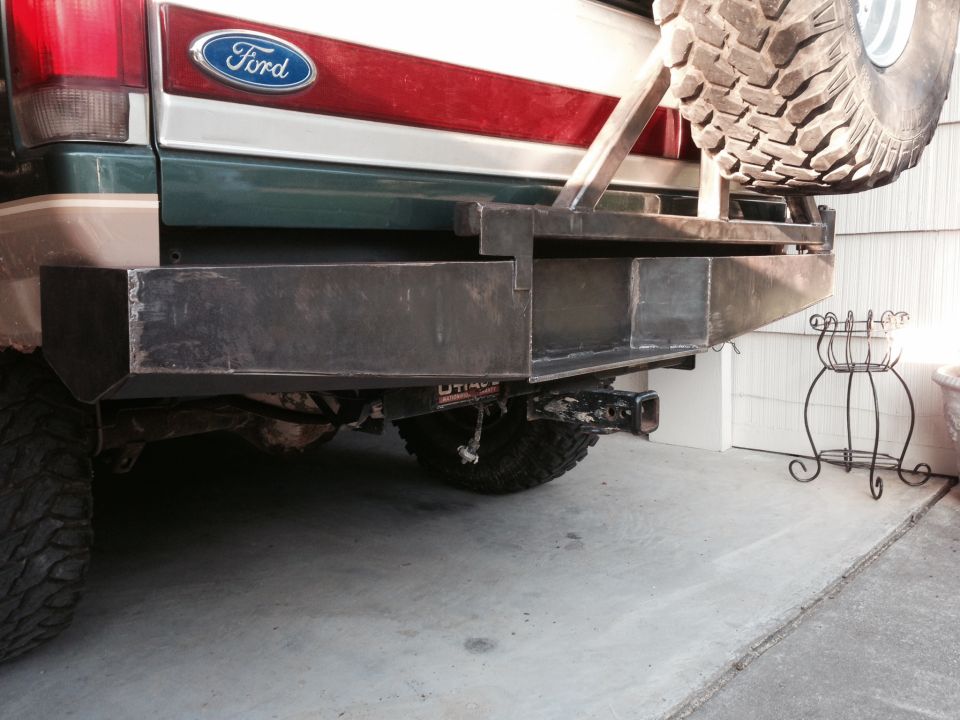 Rear view of a Ford Bronco with a custom bumper and spare tire mount.