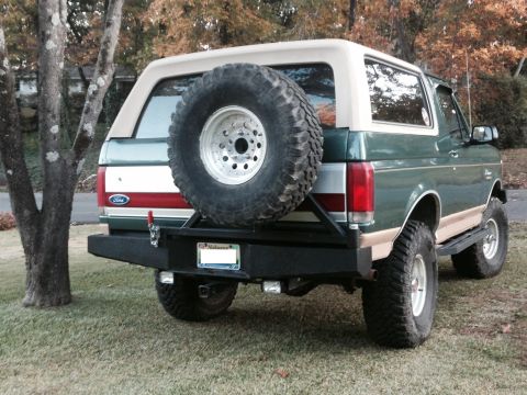 1989 Ford Bronco - This Ford Bronco features a spare tire carrier and a custom rear bumper with integrated trailer hitch.
