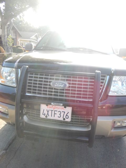 2003 Ford Crown Victoria - Front grille of a black Ford Expedition fitted with a brush guard, displaying California license plate 4XTF376.