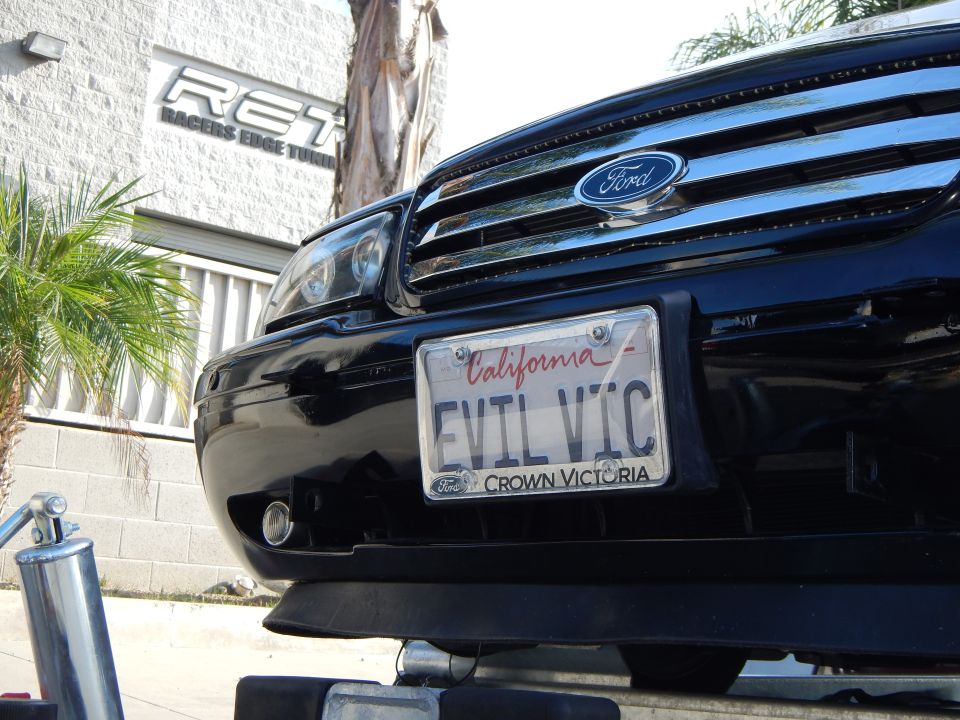 Black Ford sedan front bumper with EVIL VIC California Crown Victoria license plate