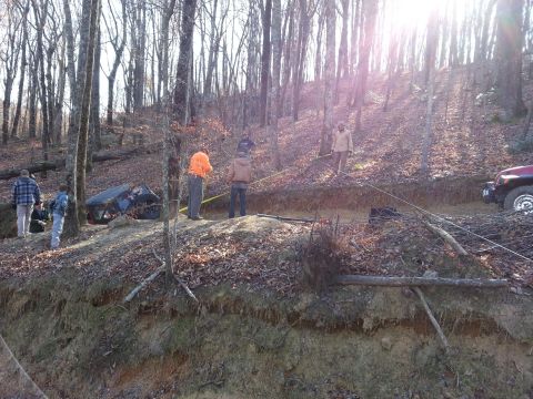 1995 Ford Bronco - A group works to recover a vehicle that has gone off-road and is stuck in a ditch.