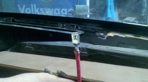 1982 Ford Bronco - A close-up view shows a red wire with a clear connector attached, possibly a modification or repair, in what appears to be the interior of…