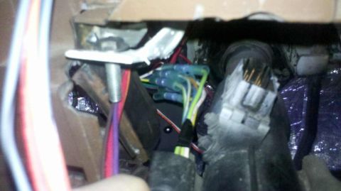 1982 Ford Bronco - This image shows a close-up view of a vehicle's wiring harness under the dashboard, with several wires connected using blue crimp connector…
