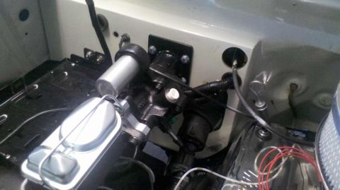 1982 Ford Bronco - A close-up view of the brake master cylinder and booster assembly in the engine bay of a classic vehicle. The brake fluid reservoir is visi…