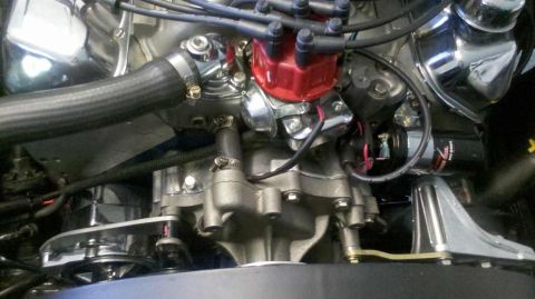 1982 Ford Bronco - A close-up view of a V8 engine, likely from a classic Ford Bronco, showing the distributor, spark plug wires, and various hoses and metal c…