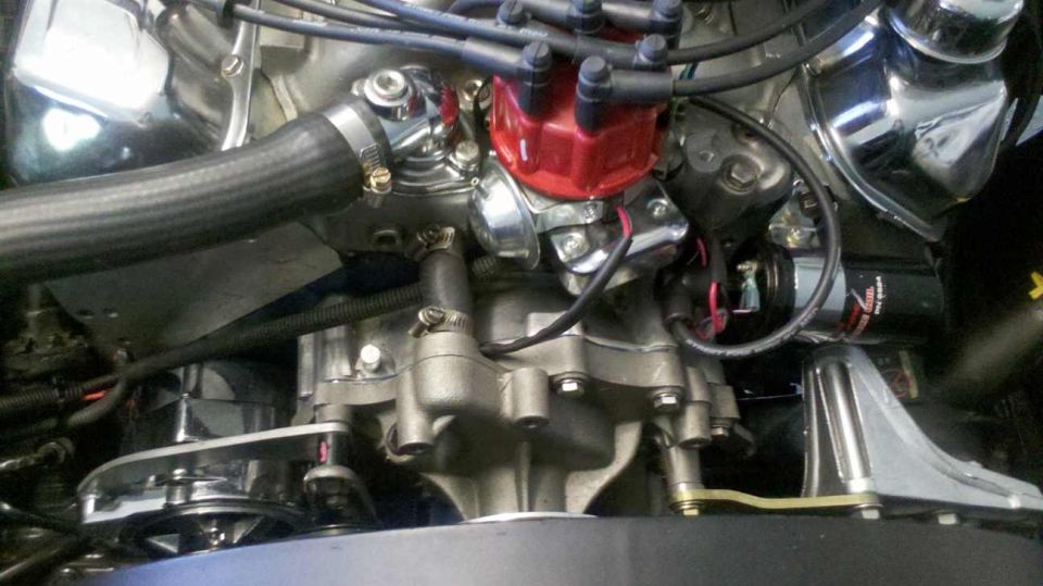 Close-up of a V8 engine with red distributor cap and chrome accents.