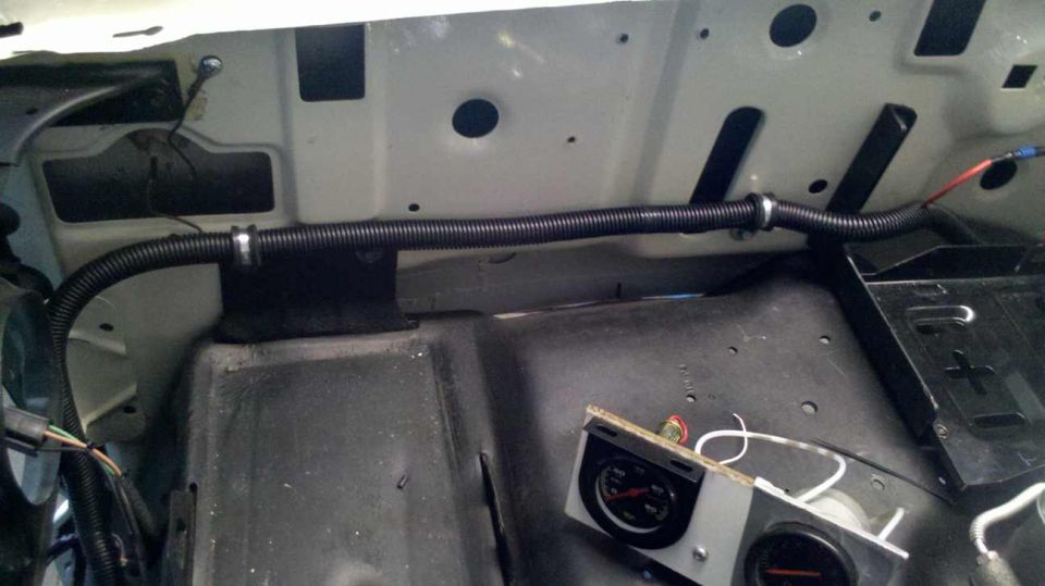 Engine bay with wiring loom and gauges