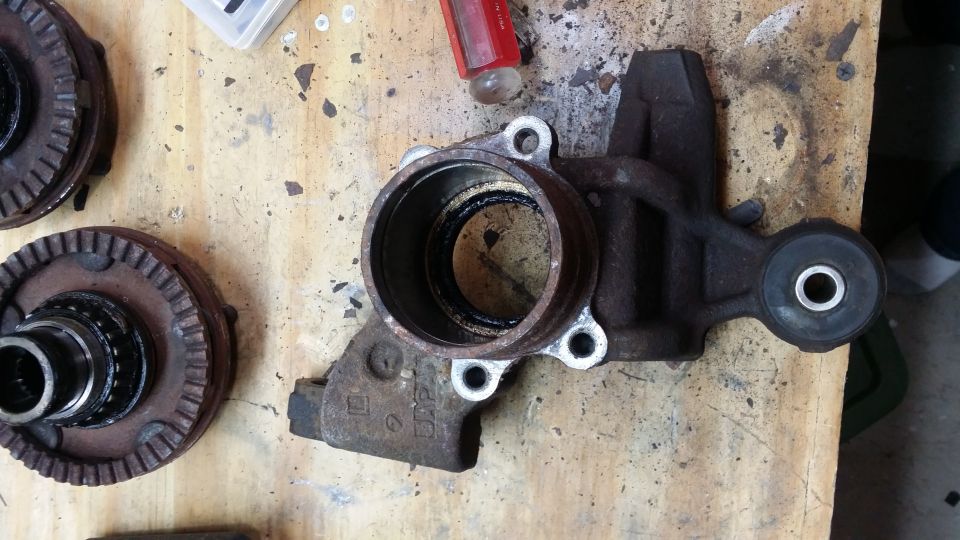 Wheel bearing hub and knuckle assembly with a separate hub on a wooden surface