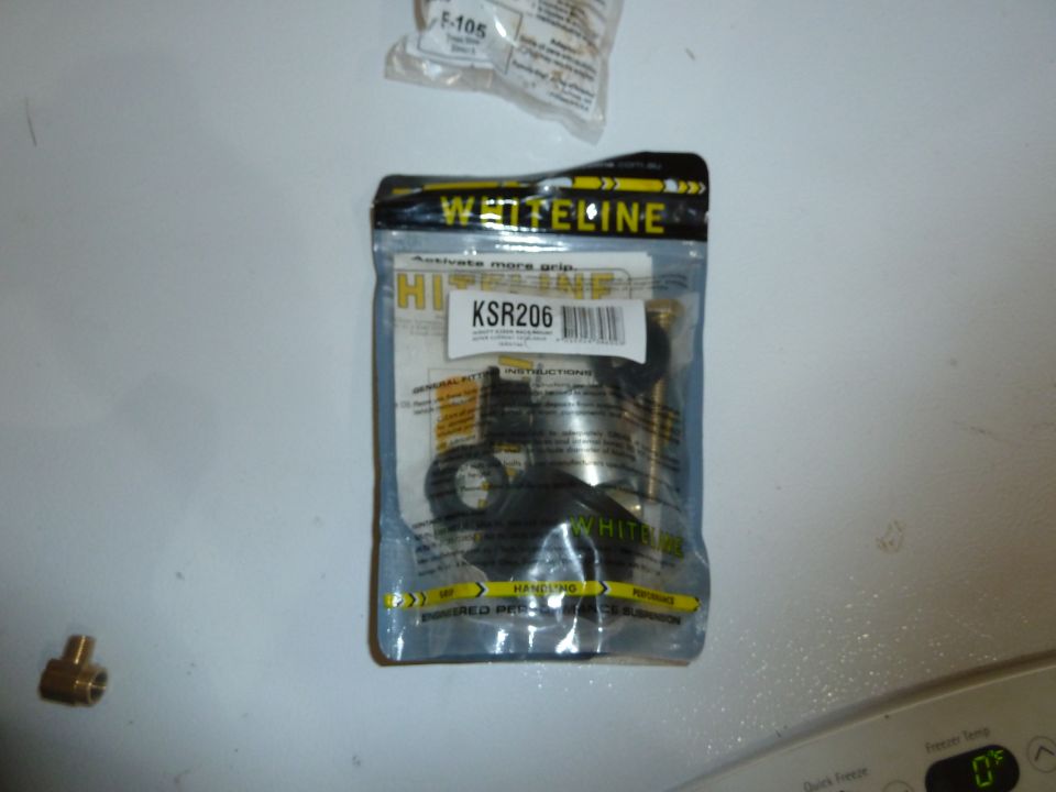 Sealed package of Whiteline KSR206 sway bar links and a brass T-fitting.