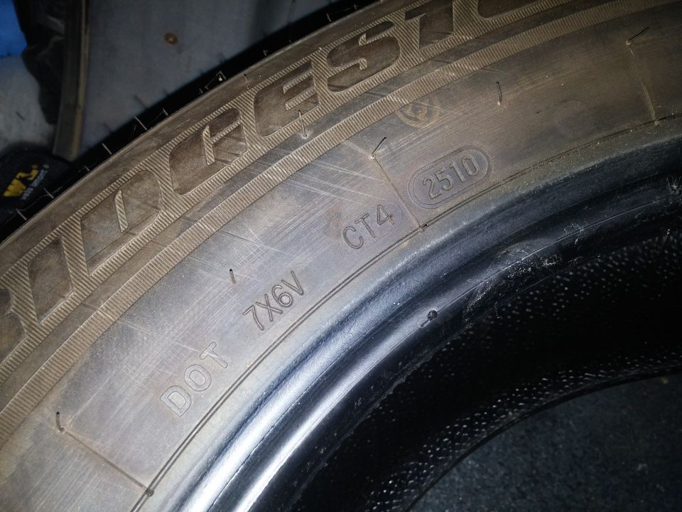 Close-up photo of a Bridgestone tire sidewall DOT code