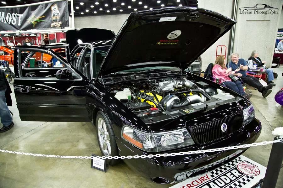 Black Mercury Marauder with hood and door open, showing engine.