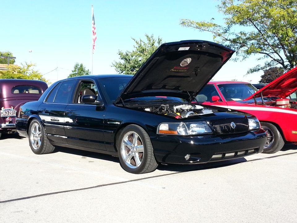 Black 2003 Mercury Marauder with hood open, parked outdoors.