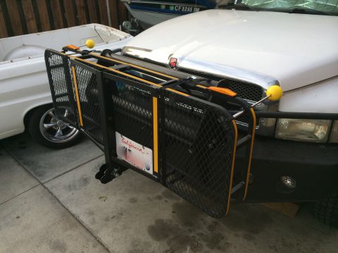 1997 Dodge 3500 - A black cargo carrier with yellow accents is mounted to the front of a white Dodge 3500 pickup truck. A California license plate is attache…