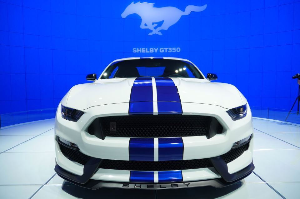 White Ford Mustang Shelby GT350 with blue stripes on display